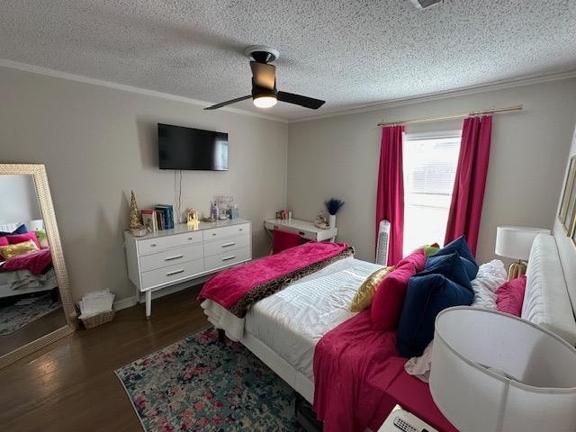 bedroom with ceiling fan, crown molding, dark hardwood / wood-style floors, and a textured ceiling