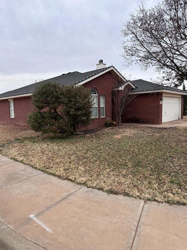 view of property exterior featuring a yard and a garage