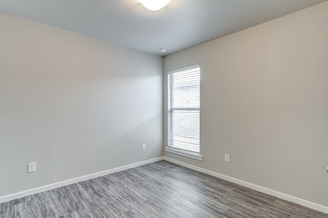 empty room featuring dark hardwood / wood-style flooring