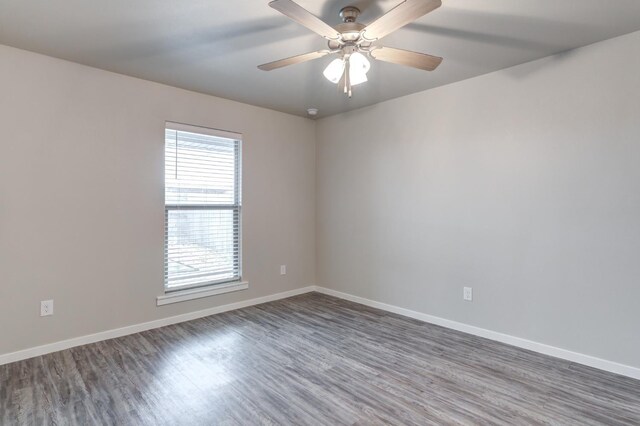 empty room with dark hardwood / wood-style floors and ceiling fan