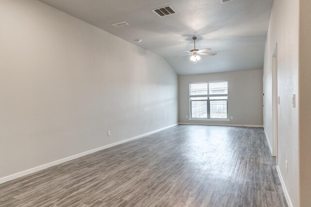 empty room featuring dark hardwood / wood-style flooring, ceiling fan, and lofted ceiling