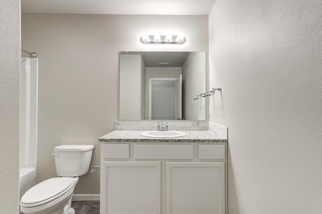 full bathroom featuring vanity,  shower combination, and toilet