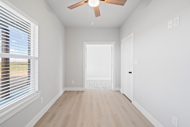 empty room with light hardwood / wood-style flooring and ceiling fan