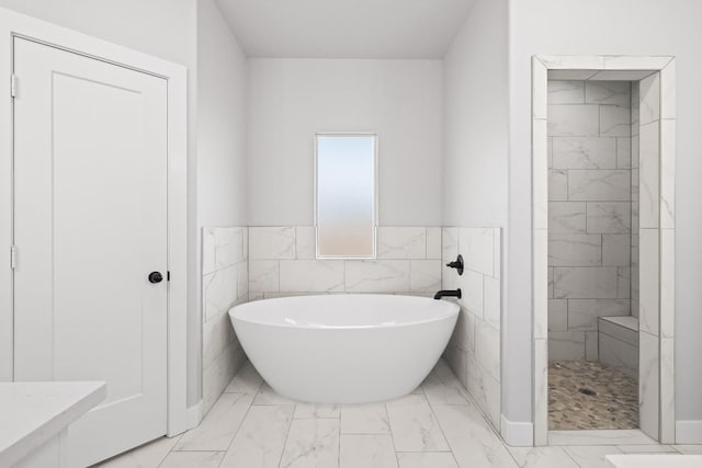 bathroom with separate shower and tub and tile walls