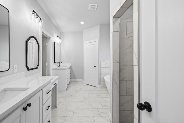 bathroom with vanity and a tub