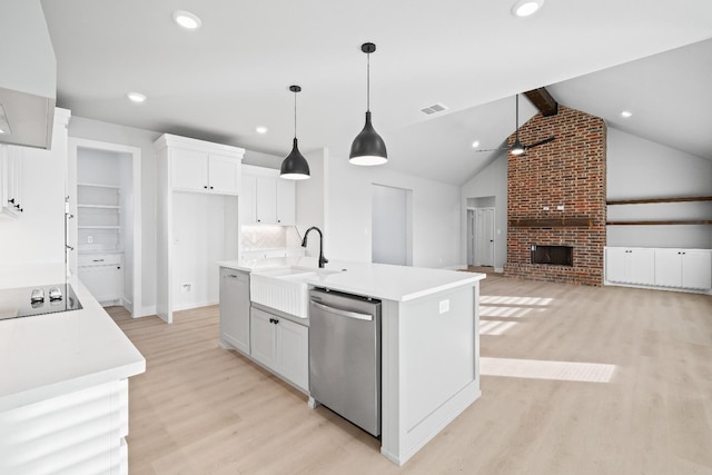 kitchen with white cabinetry, stainless steel dishwasher, decorative light fixtures, and a center island with sink