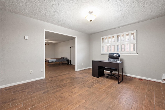 3808 27th St, Lubbock, TX 79410 - office featuring wood finished floors, a textured ceiling, and a textured wall