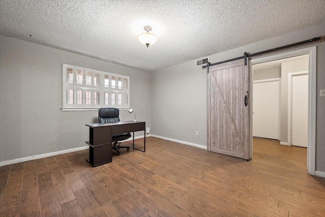 3808 27th St, Lubbock, TX 79410 - office space with a barn door, wood finished floors, and a textured ceiling