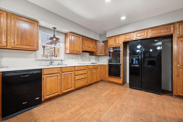 3808 27th St, Lubbock, TX 79410 - kitchen featuring black appliances, light wood-type flooring, light countertops, and brown cabinets
