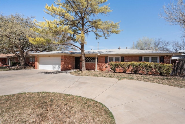 3808 27th St, Lubbock, TX 79410 - ranch-style home featuring brick siding, a garage, and driveway