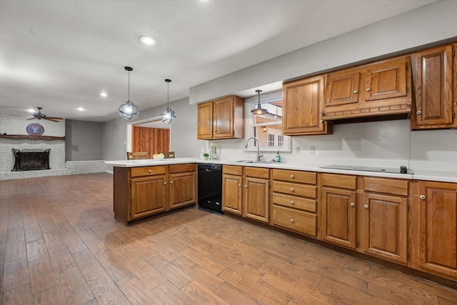 3808 27th St, Lubbock, TX 79410 - kitchen featuring black appliances, brown cabinets, a peninsula, a ceiling fan, and light countertops