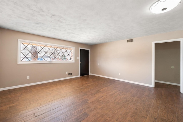 3808 27th St, Lubbock, TX 79410 - empty room featuring dark wood finished floors and a textured ceiling