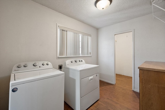 3808 27th St, Lubbock, TX 79410 - washroom with separate washer and dryer, wood finished floors, and a textured ceiling