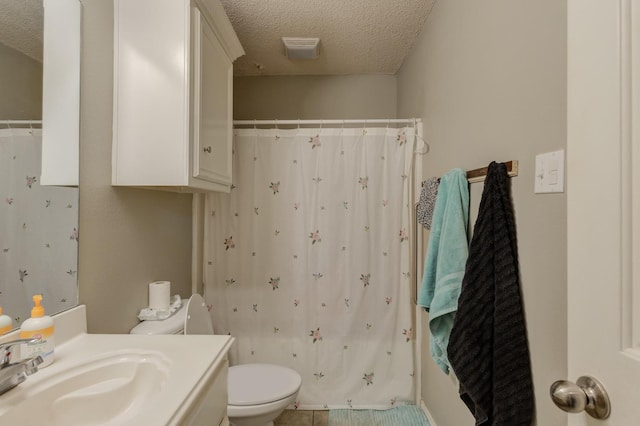 bathroom with sink, curtained shower, a textured ceiling, and toilet