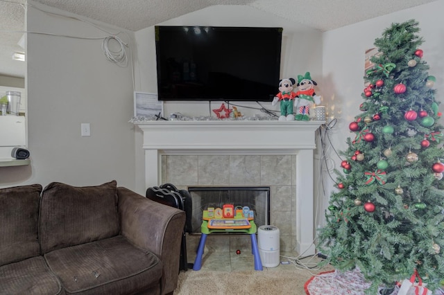 carpeted living room featuring a fireplace, a textured ceiling, and vaulted ceiling