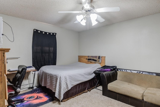 carpeted bedroom featuring ceiling fan and a textured ceiling