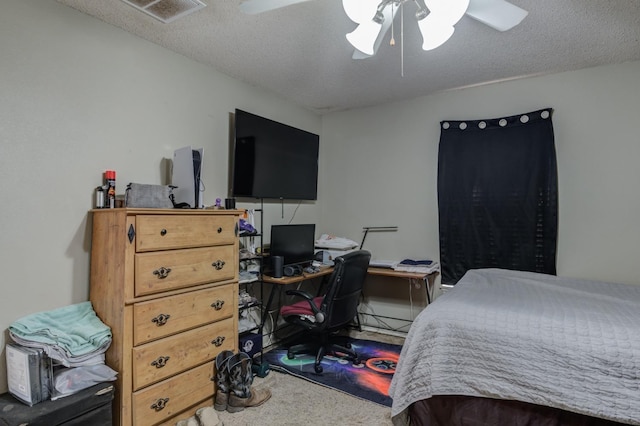 bedroom featuring ceiling fan and a textured ceiling