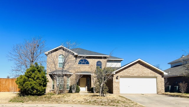 view of front of house with driveway, a garage, fence, and brick siding