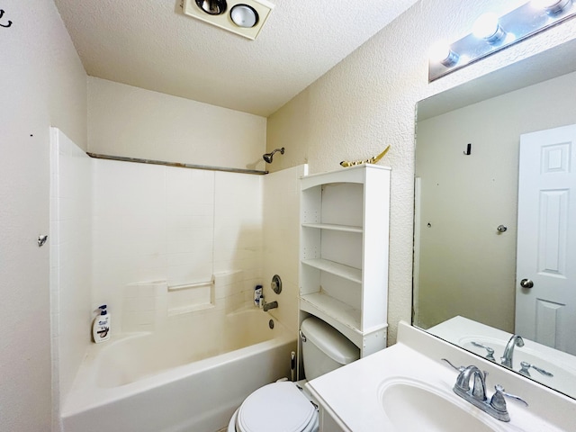 bathroom with bathtub / shower combination, a textured wall, toilet, a textured ceiling, and vanity