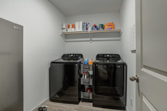 6904 56th St, Lubbock, TX 79407 - laundry area with washer and clothes dryer, light wood-style floors, and baseboards