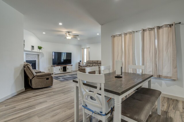 6904 56th St, Lubbock, TX 79407 - dining space with light wood finished floors, recessed lighting, a ceiling fan, a fireplace, and baseboards