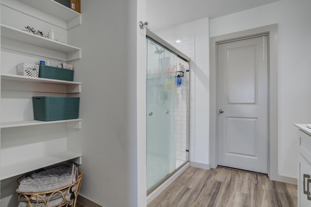 6904 56th St, Lubbock, TX 79407 - bathroom with a stall shower and wood finished floors