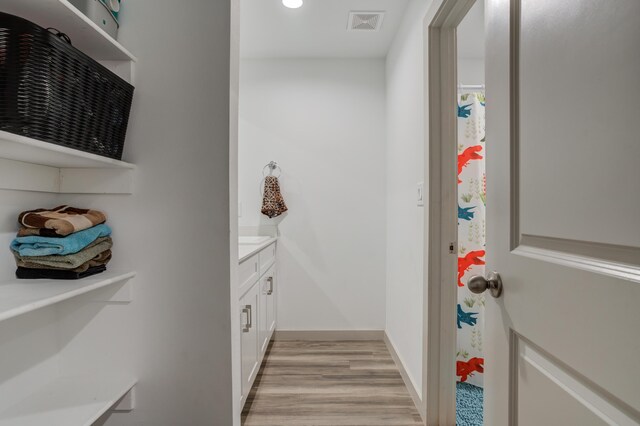 6904 56th St, Lubbock, TX 79407 - bathroom with vanity, wood finished floors, baseboards, and recessed lighting