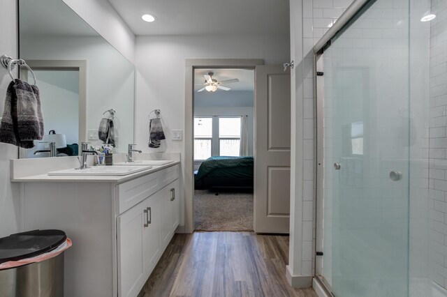 6904 56th St, Lubbock, TX 79407 - full bathroom featuring ceiling fan, wood finished floors, a stall shower, ensuite bath, and double vanity