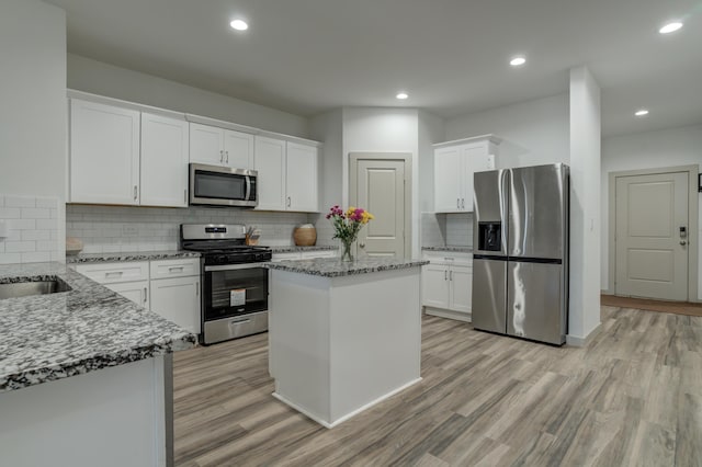 6904 56th St, Lubbock, TX 79407 - kitchen with appliances with stainless steel finishes, light stone countertops, white cabinetry, and recessed lighting