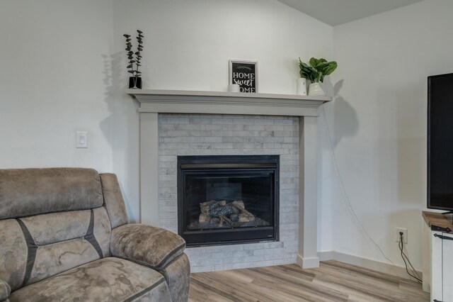 6904 56th St, Lubbock, TX 79407 - detailed view of wood finished floors, baseboards, and a brick fireplace