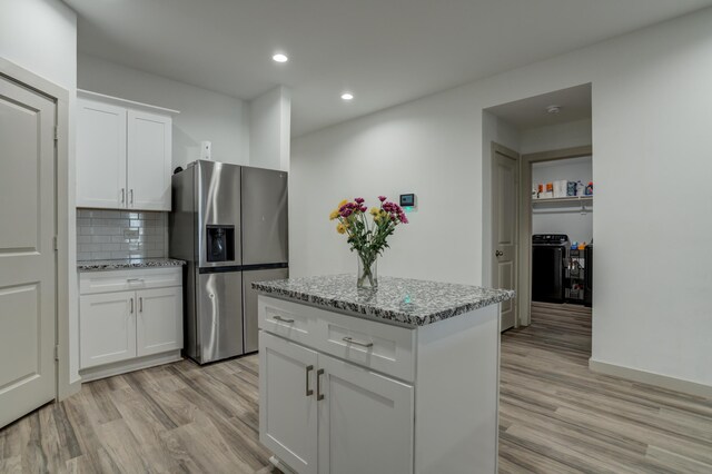 6904 56th St, Lubbock, TX 79407 - kitchen featuring stainless steel fridge with ice dispenser, light wood-type flooring, recessed lighting, decorative backsplash, and light stone countertops