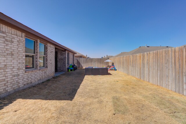 6904 56th St, Lubbock, TX 79407 - fenced backyard featuring an outdoor living space