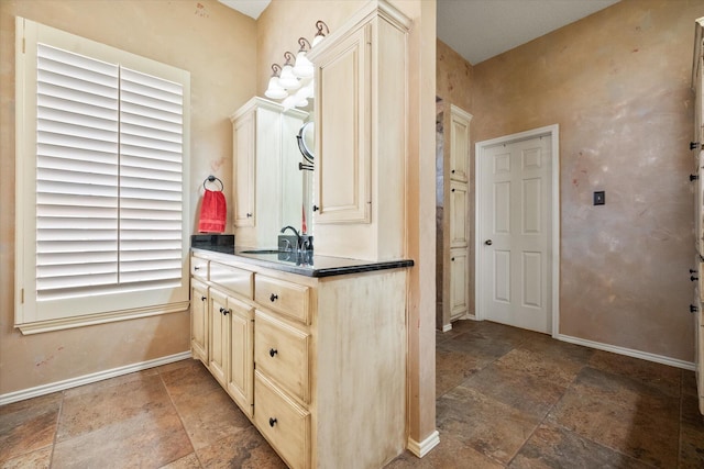 4121 86th St, Lubbock, TX 79423 - bathroom with baseboards, vanity, and stone finish floor