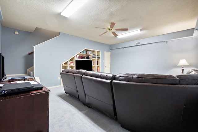 4121 86th St, Lubbock, TX 79423 - living area featuring a textured ceiling, visible vents, ceiling fan, light carpet, and stairs