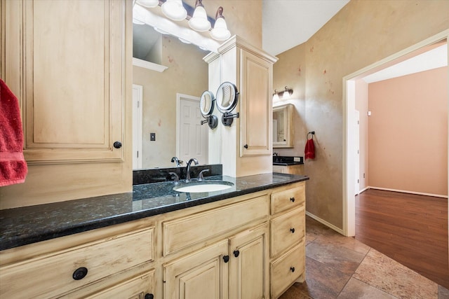 4121 86th St, Lubbock, TX 79423 - bathroom with baseboards, stone finish flooring, and vanity