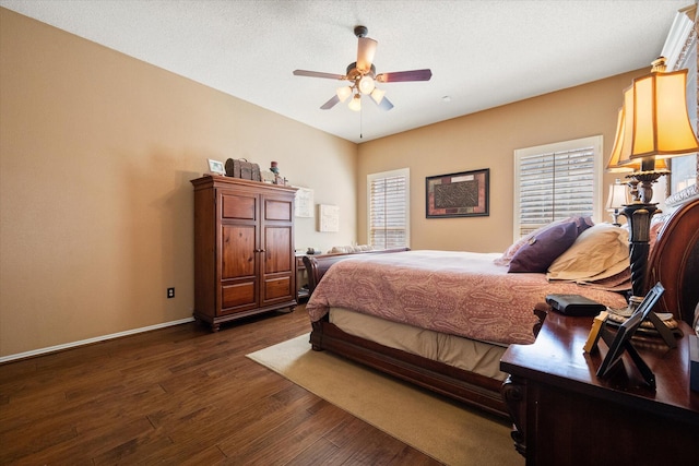 4121 86th St, Lubbock, TX 79423 - bedroom with baseboards, dark wood-style flooring, and ceiling fan