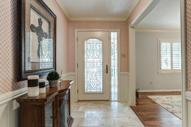 entryway with crown molding and a textured ceiling