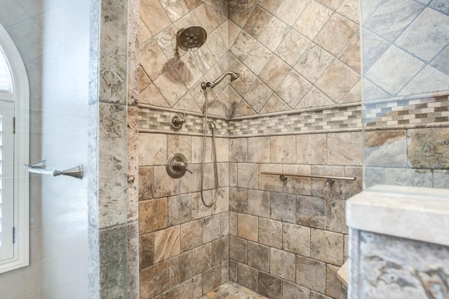 bathroom with a tile shower