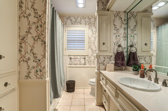 bathroom featuring ornate columns, tile patterned flooring, vanity, toilet, and crown molding