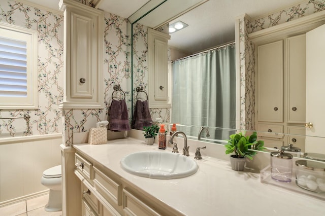 bathroom featuring decorative columns, vanity, tile patterned flooring, and toilet