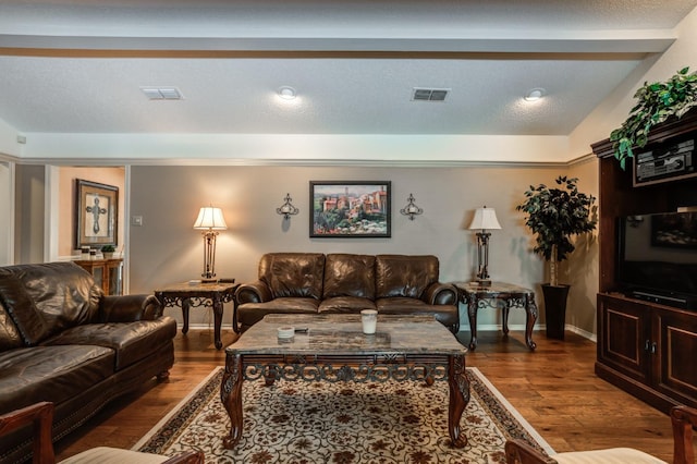 living room with hardwood / wood-style flooring and a textured ceiling