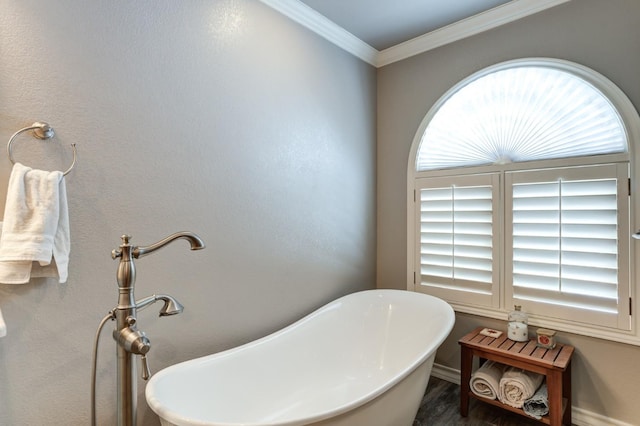 bathroom with a washtub and crown molding