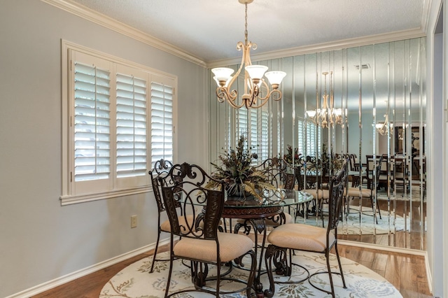 dining space with hardwood / wood-style flooring, ornamental molding, and a chandelier