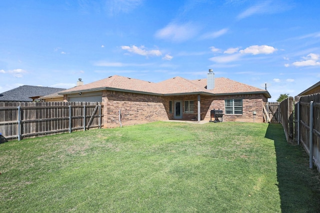 rear view of house with a yard