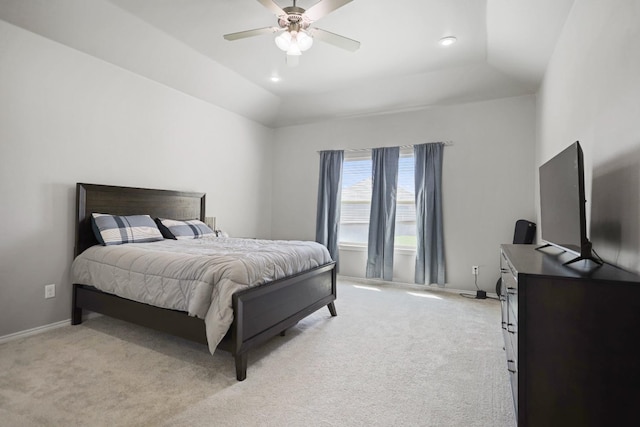 carpeted bedroom featuring lofted ceiling, a tray ceiling, and ceiling fan