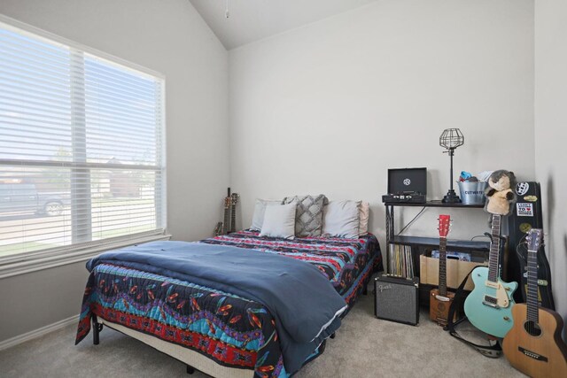 carpeted bedroom with lofted ceiling