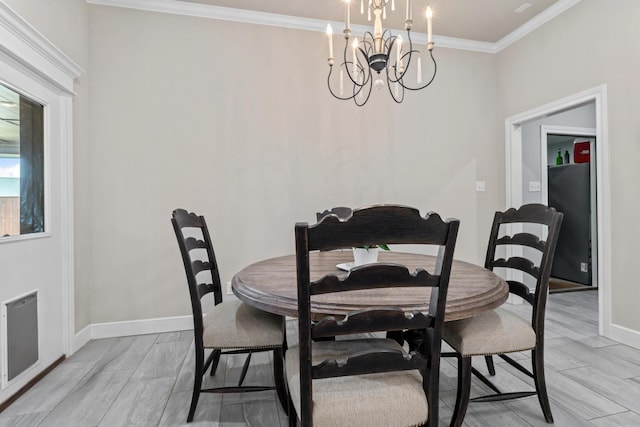 dining room with a notable chandelier and crown molding