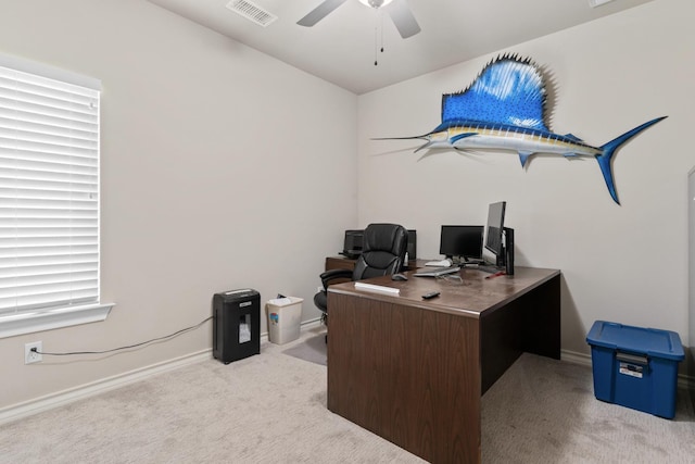 carpeted home office featuring ceiling fan