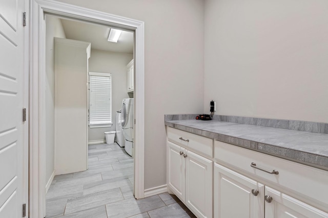 bathroom featuring washing machine and dryer and tile patterned floors