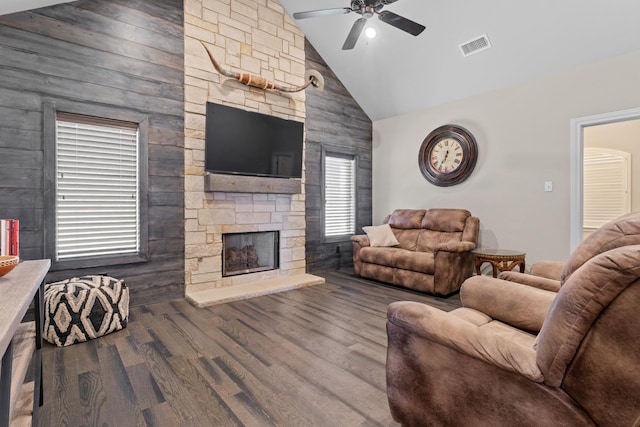 living room featuring ceiling fan, lofted ceiling, hardwood / wood-style floors, and a fireplace